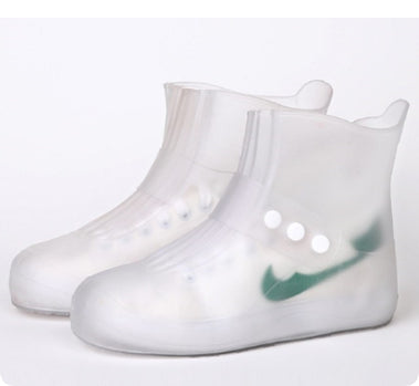 Clear rain boots with a green logo on a white background