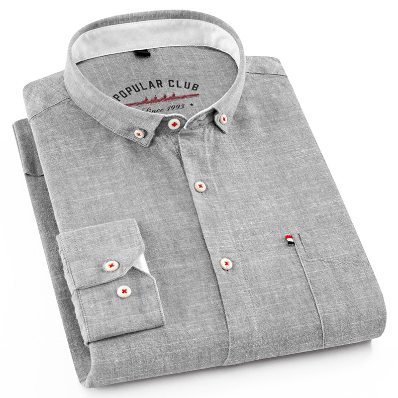 Folded gray shirt with a collar brand on a white background