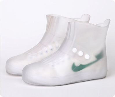 Clear rain boots with a green logo on a white background