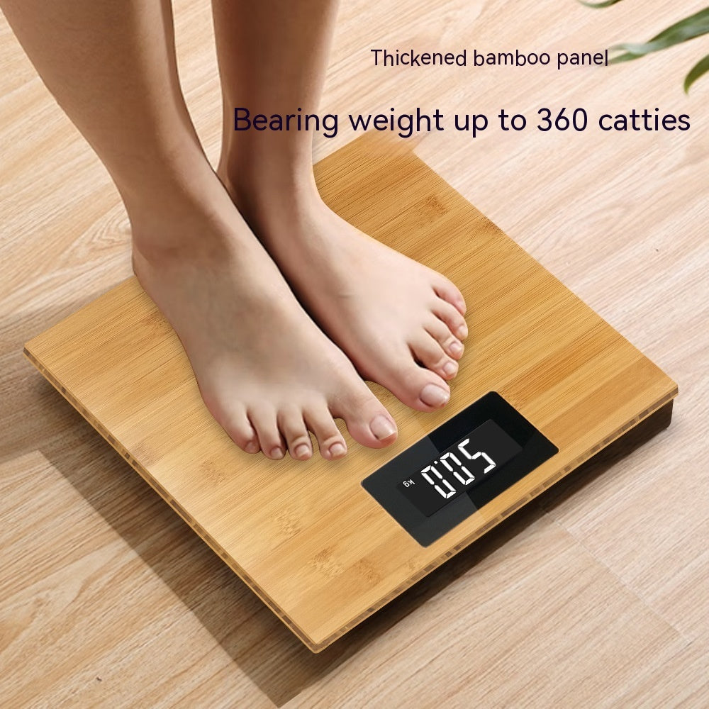 Wooden digital scale with a person stepping on it, displaying weight, on a wooden floor.