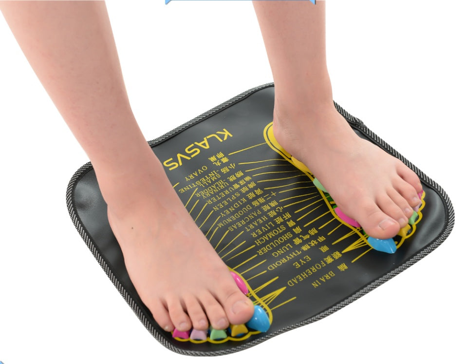 Person using a foot reflexology mat with labeled acupressure points on a white background