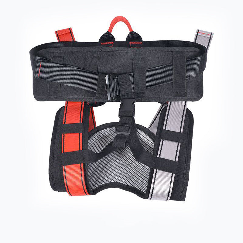 A black climbing harness with red and silver reflective straps, a black mesh belly pad, and a top hanging loop, shown against a plain white background.