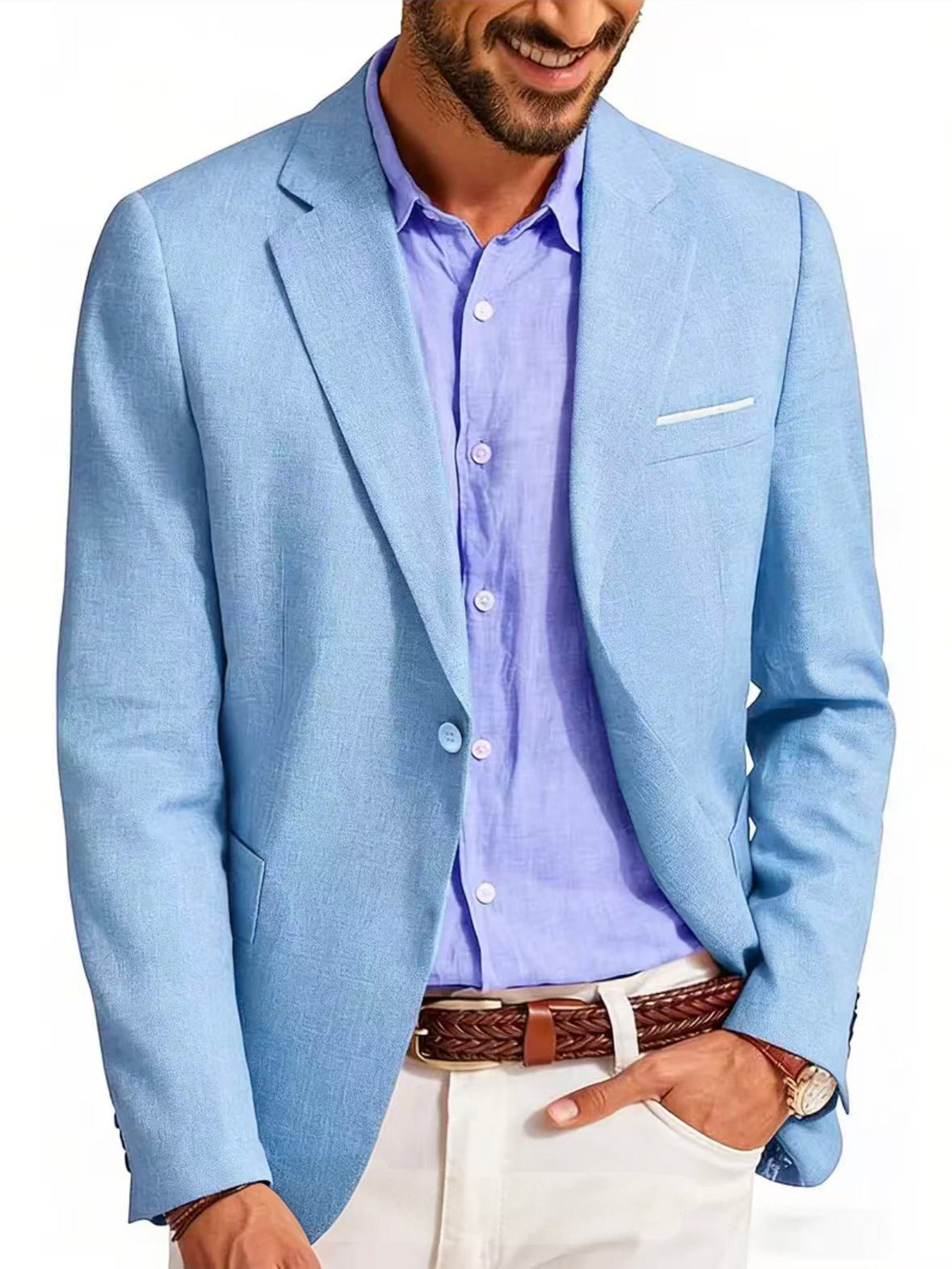 Man wearing a light blue blazer over a purple shirt with white pants on a white background
