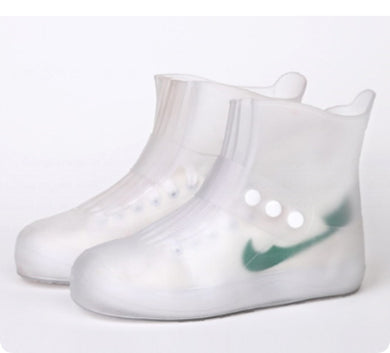 Clear rain boots with a green logo on a white background