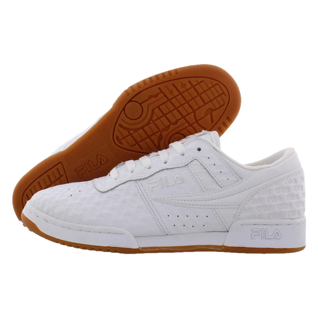 A pair of white FILA low-top sneakers, with one shoe showing the textured white leather upper and the other showing the brown rubber outsole, set against a plain white background.