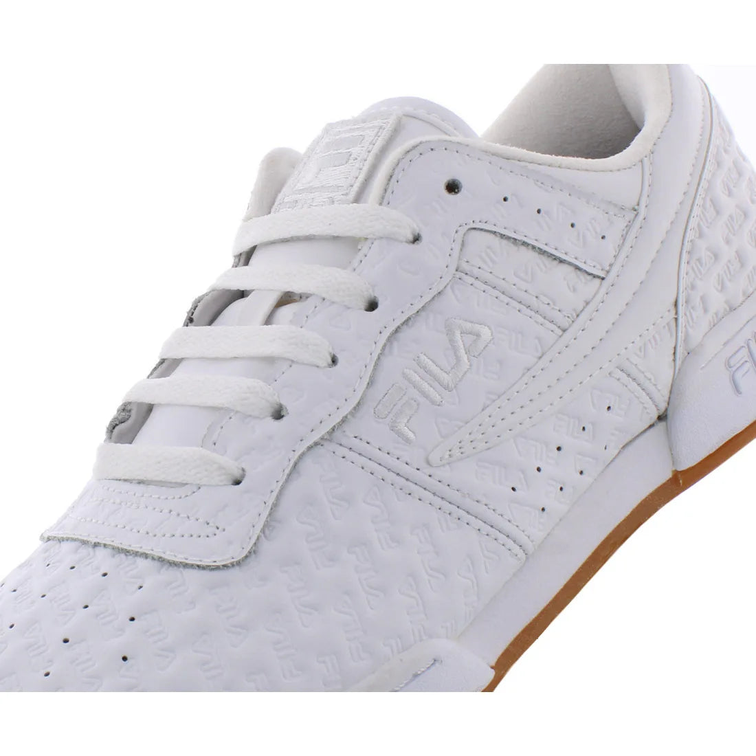 A close-up of a white FILA sneaker featuring an embossed monogram pattern, white laces, and a gum brown outsole, shown against a plain white background.