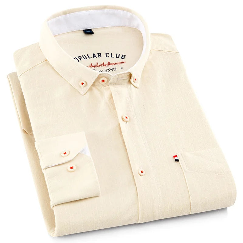 Folded beige shirt with white collar on a white background