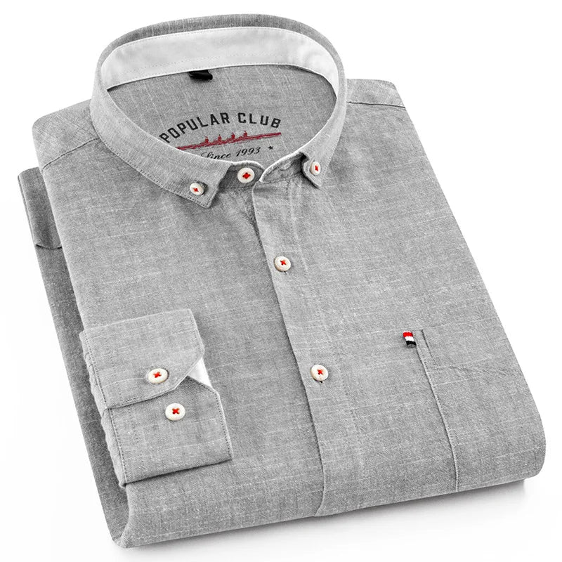Folded gray shirt with a collar brand on a white background