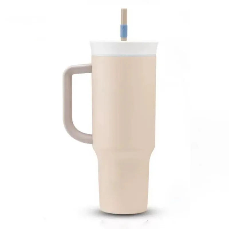 Cream travel tumbler with taupe handle, white lid and two-tone straw on a white background.