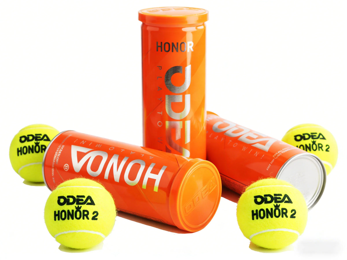 Orange Vonh Honor 2 tennis balls and matching orange and yellow tennis canisters on a clean white background.