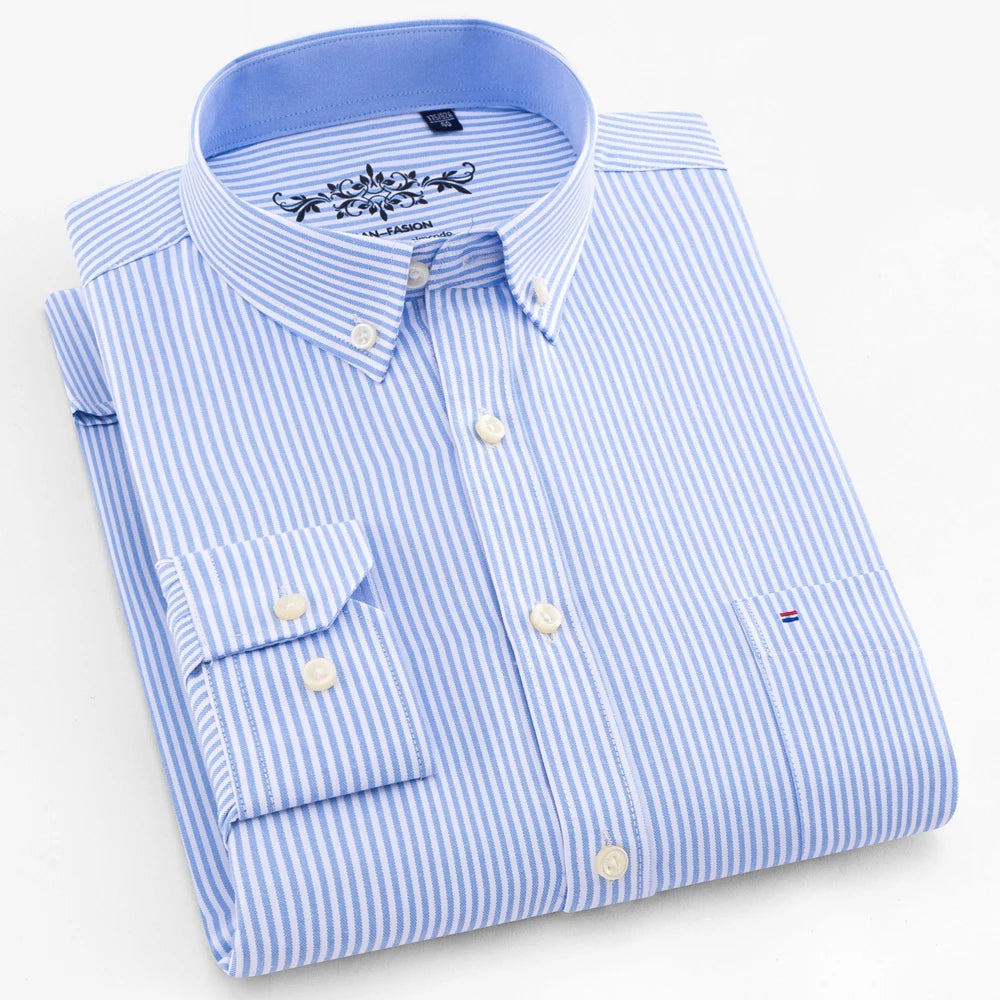 Folded blue and white striped dress shirt on a white background