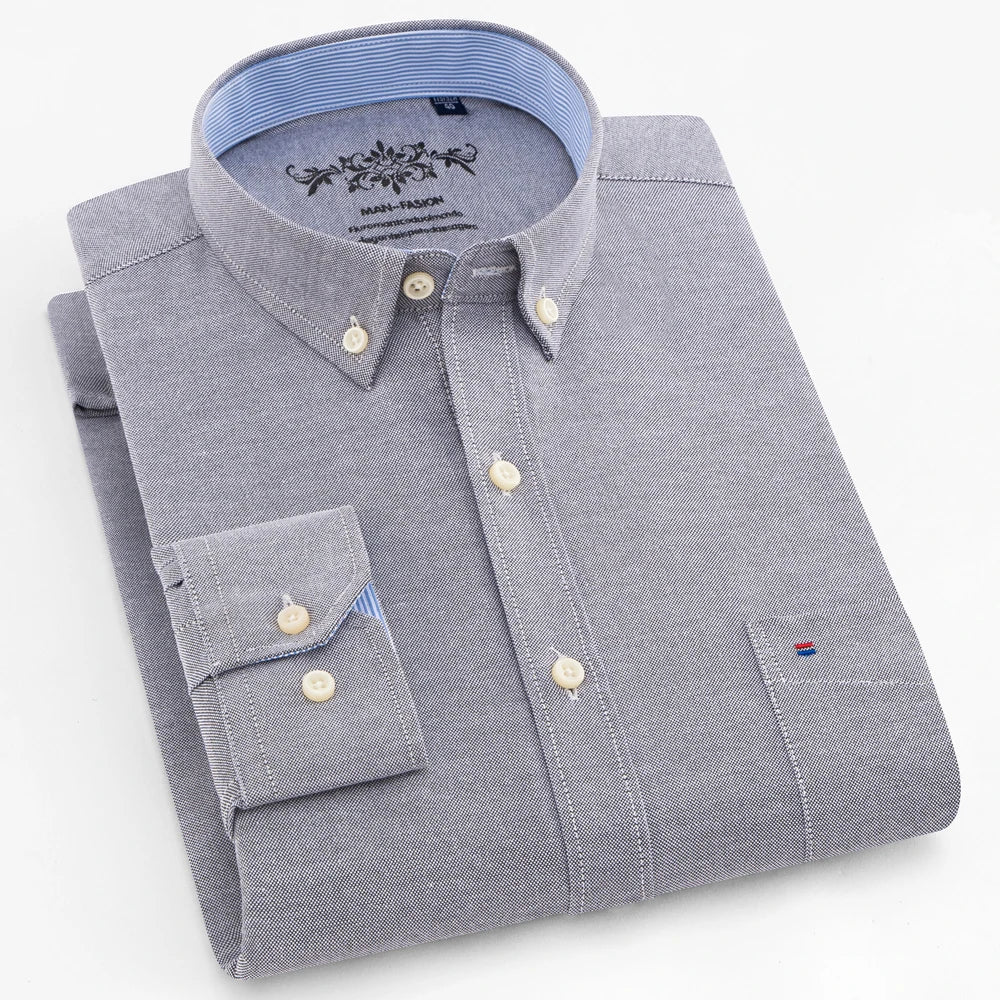 Folded gray dress shirt with brand logo on a light gray background