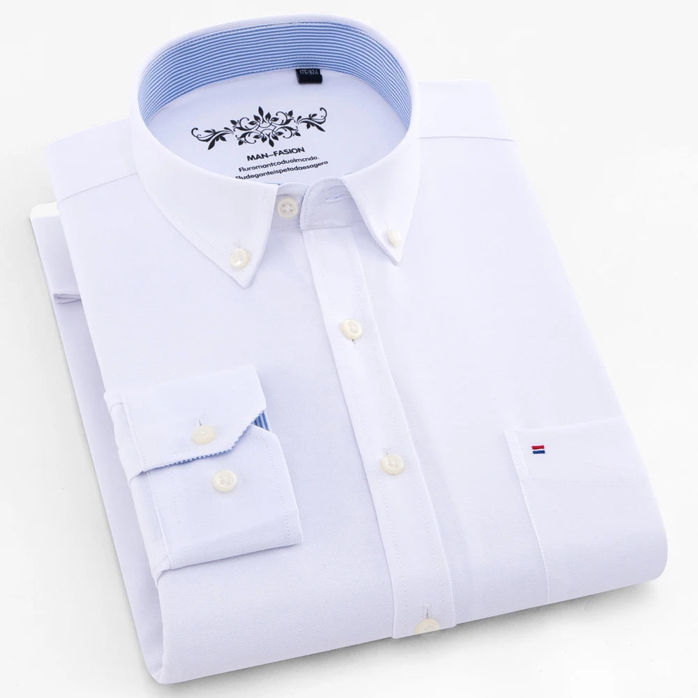 Folded white dress shirt with blue collar on a light gray background