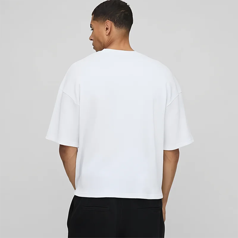Person wearing a white t-shirt on a plain background