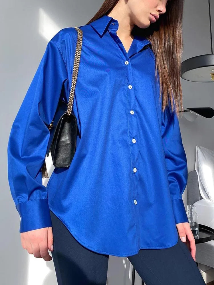 Person wearing a blue shirt with a blurred background