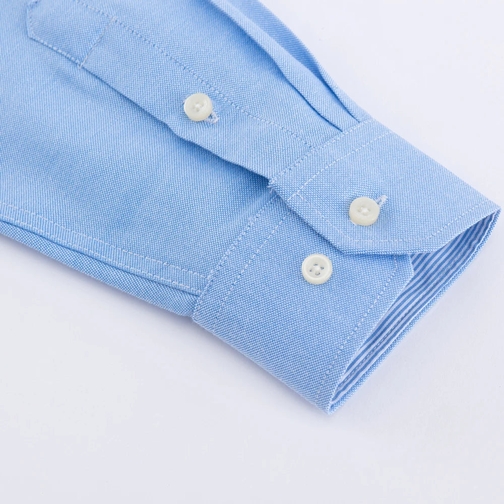 Close-up of a light blue shirt with buttons on a white background