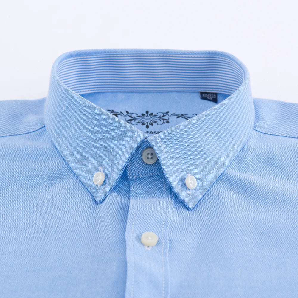 Close-up of a light blue shirt with a collar and buttons on a white background