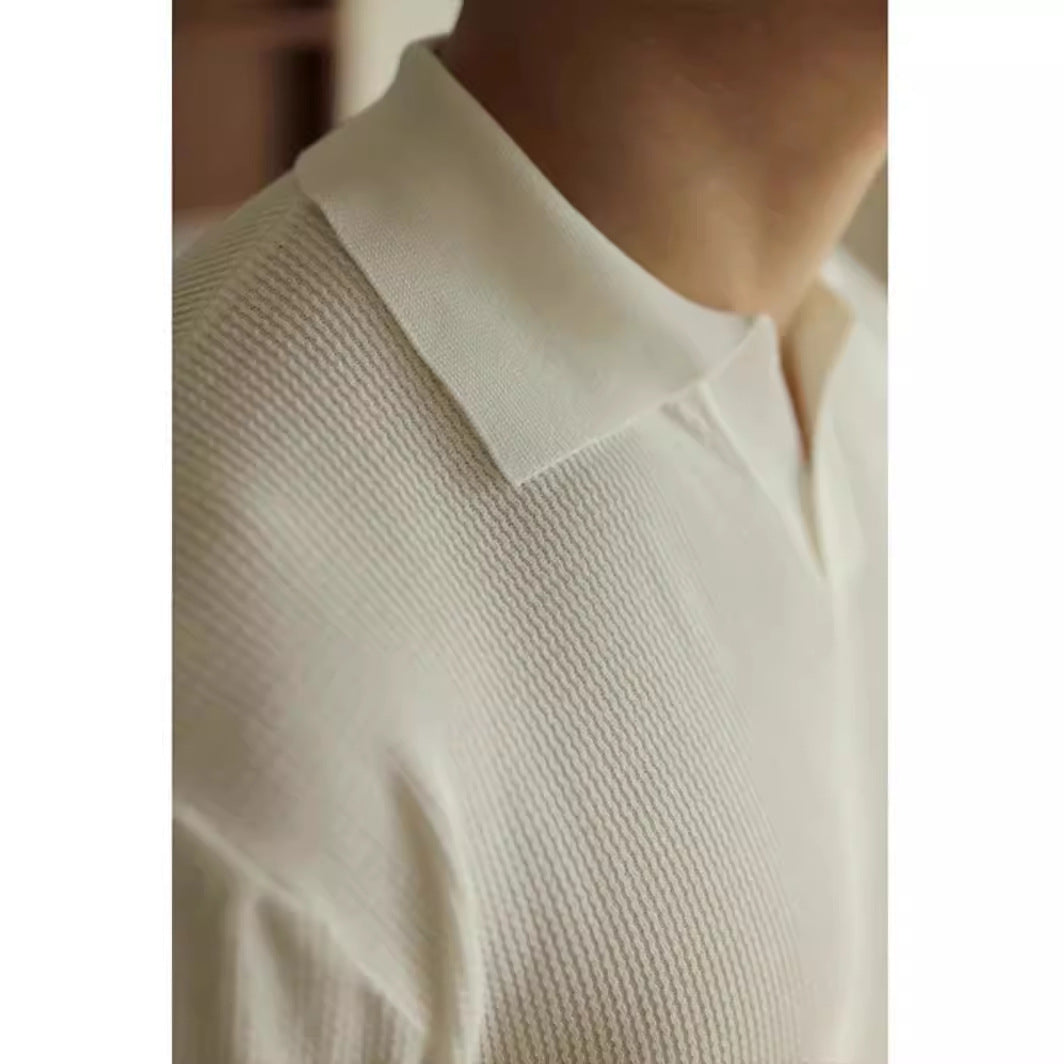 Close-up of a person wearing a textured white shirt with a blurred background