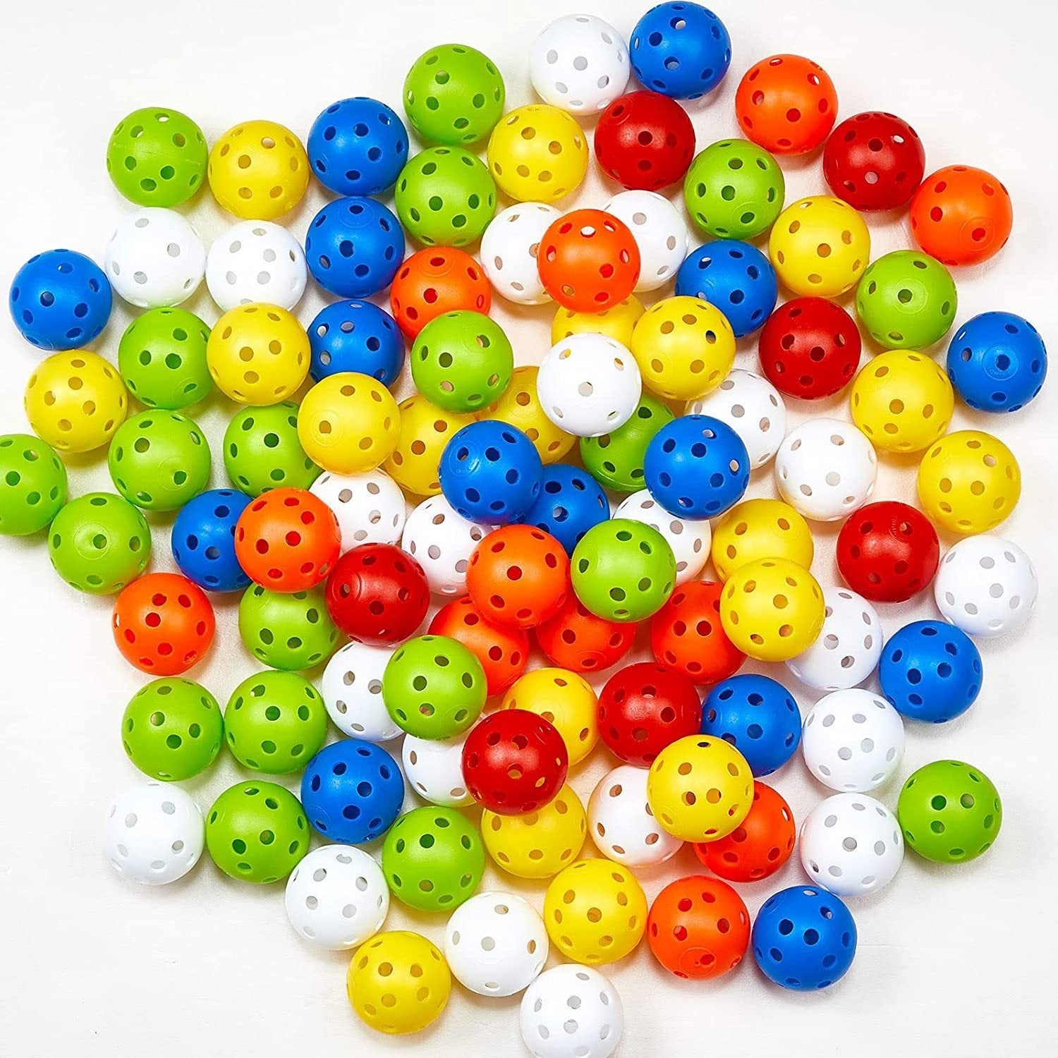 Colorful plastic balls with holes on a white background