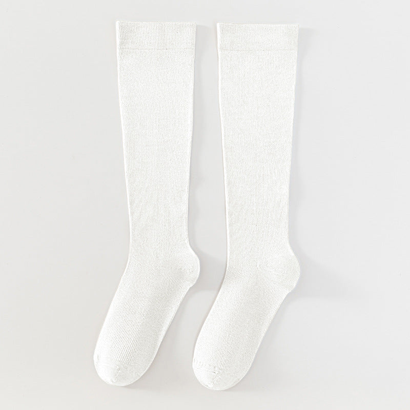 A pair of off-white, knee-high ribbed socks displayed flat against a light gray background.