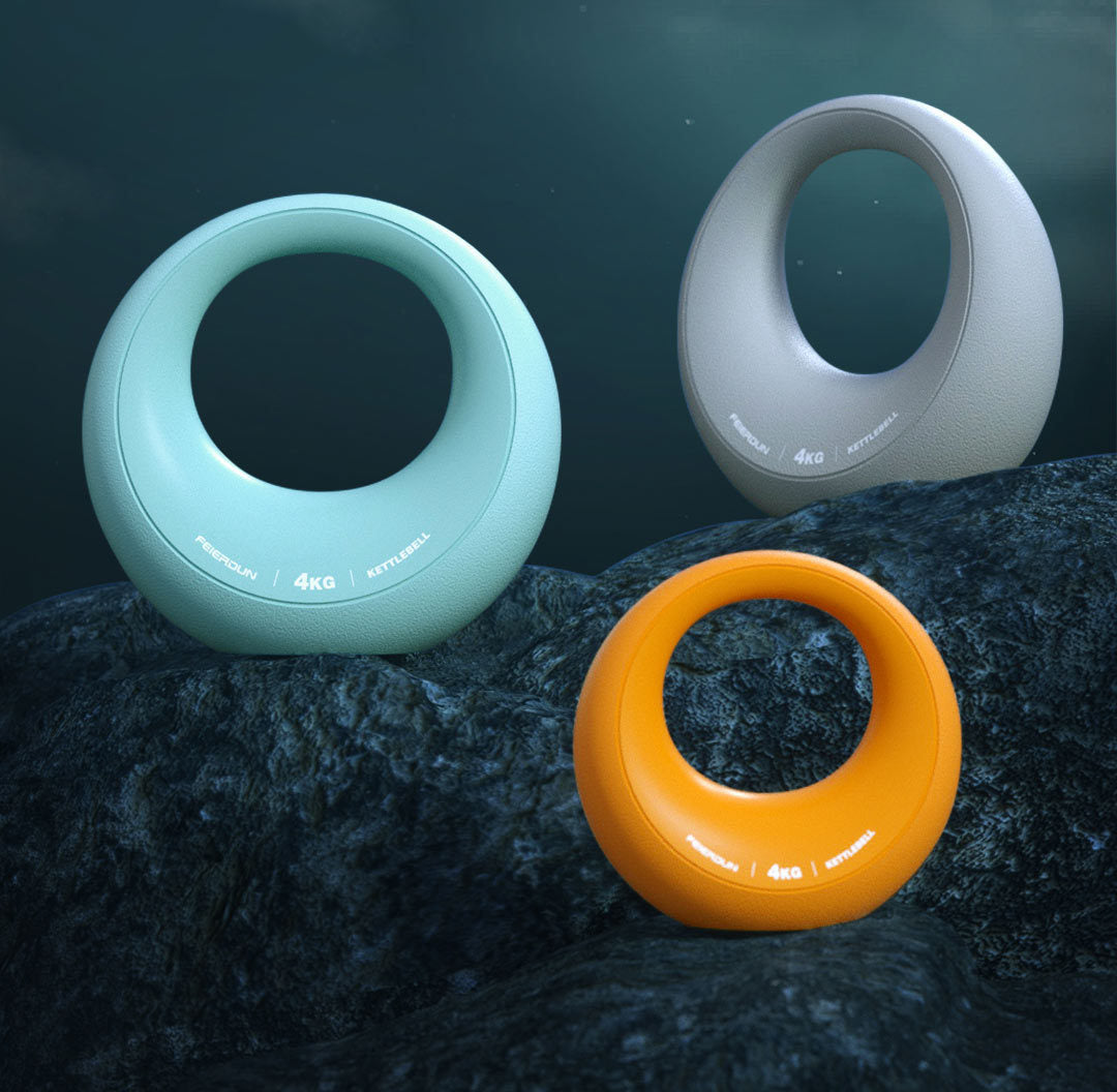 Three dog toys in green, gray, and orange on a dark textured surface
