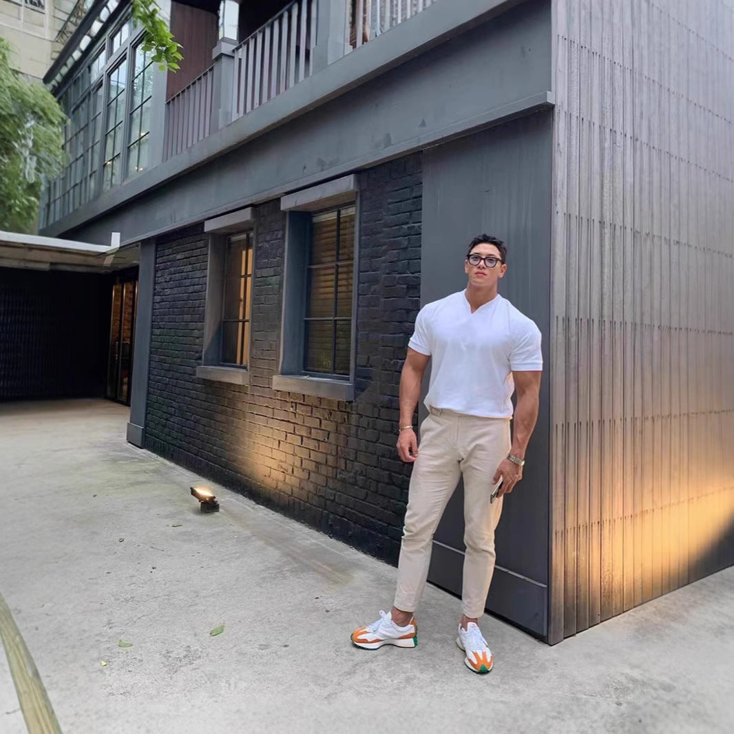 Man standing in front of a modern building with glass windows