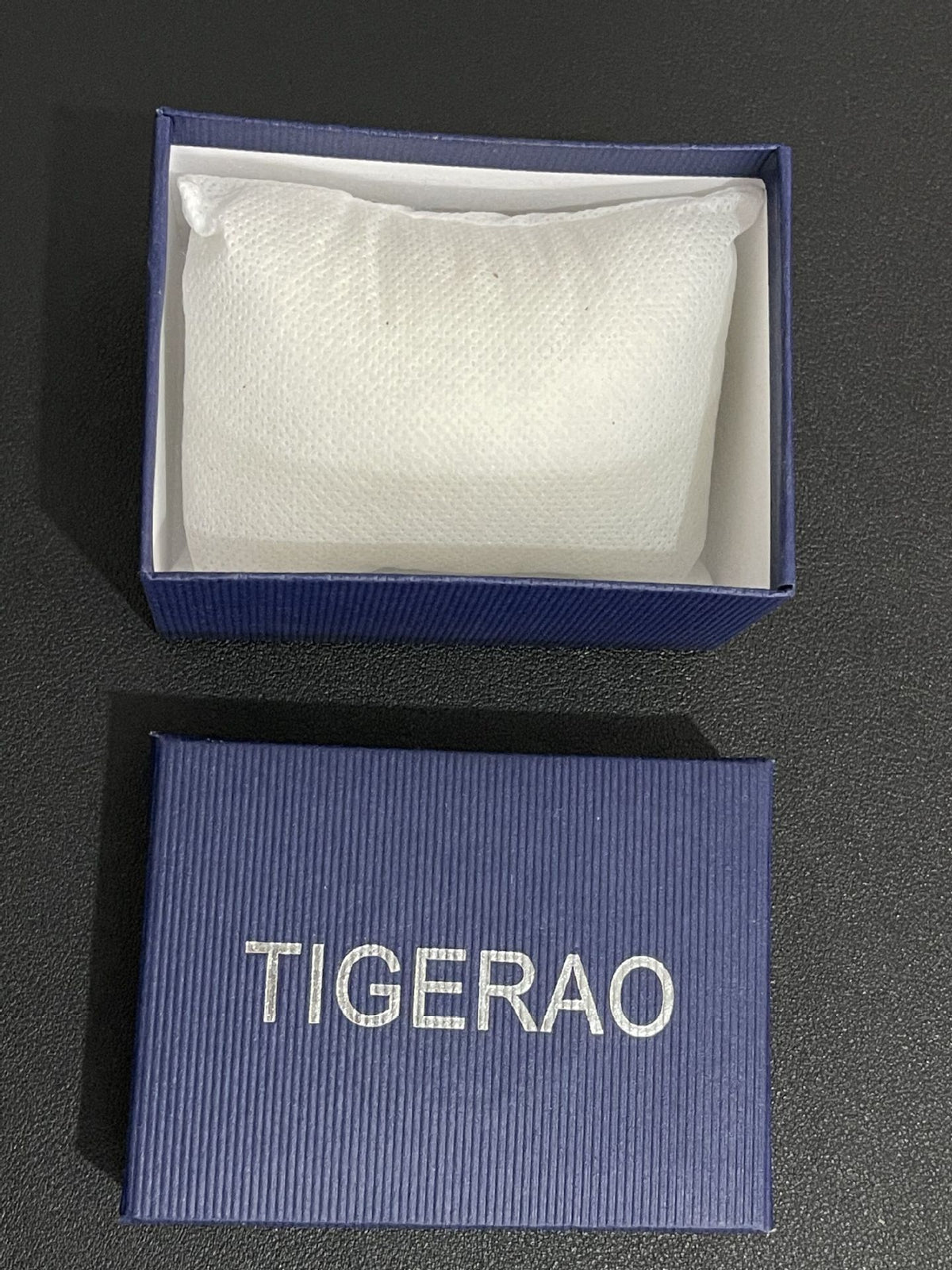 Blue box with white interior and 'TIGERAO' branding on a dark surface