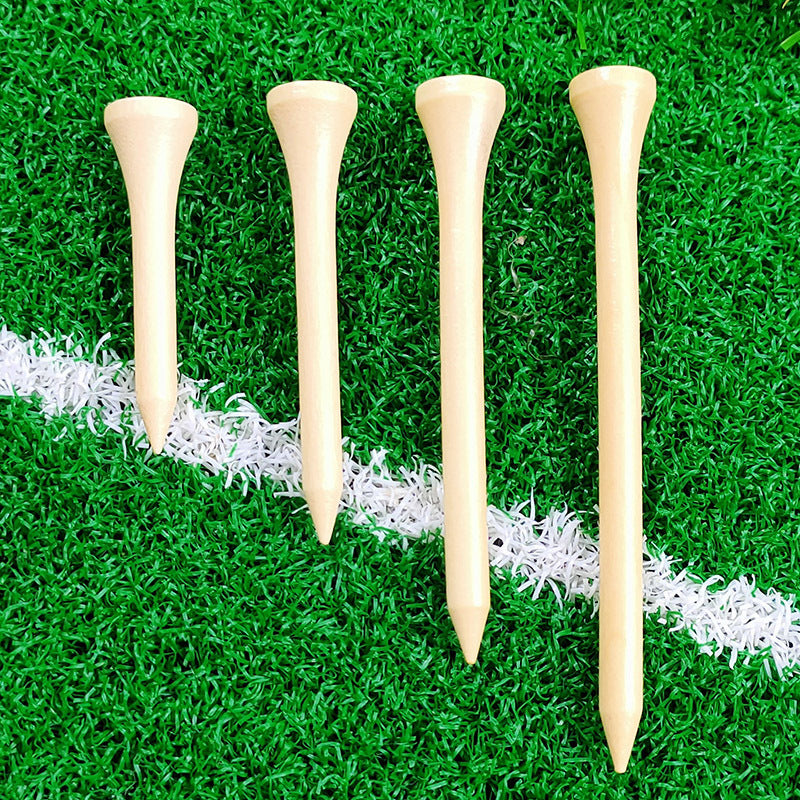 Four wooden golf tees on a green grass background
