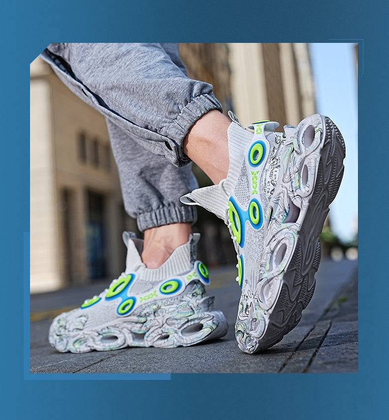 Person wearing gray sneakers with green and blue accents on a blurred street background