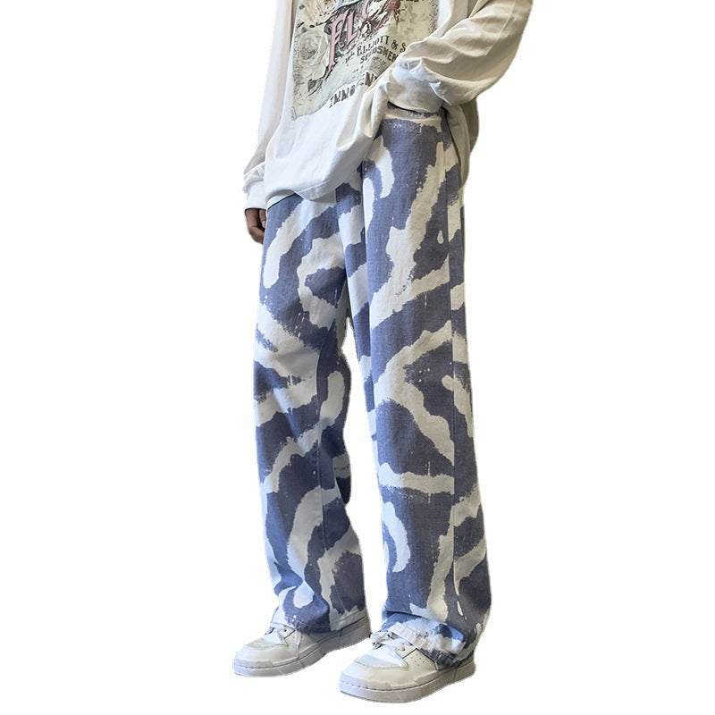 Person wearing blue and white camouflage pants on a white background