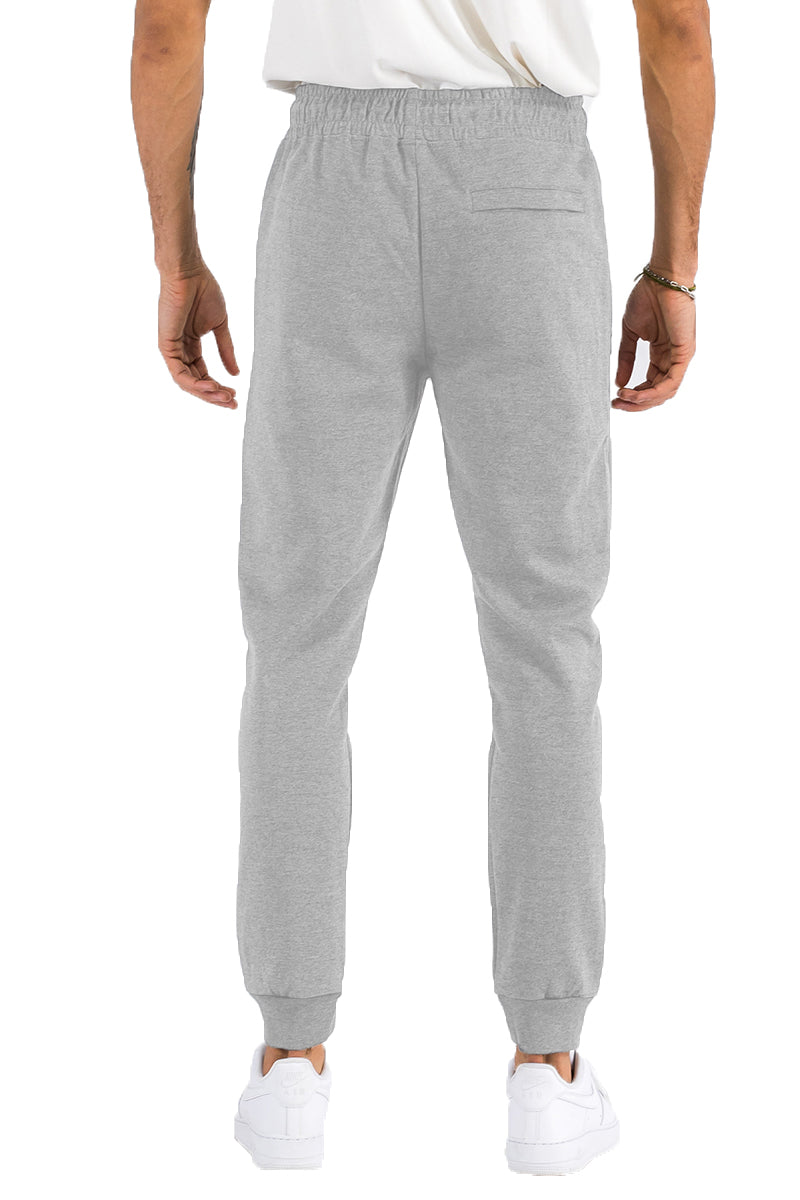 Gray sweatpants worn by a person on a white background