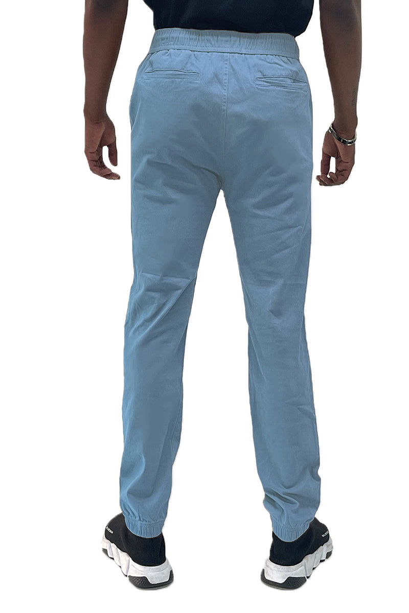 Light blue pants worn by a person on a white background