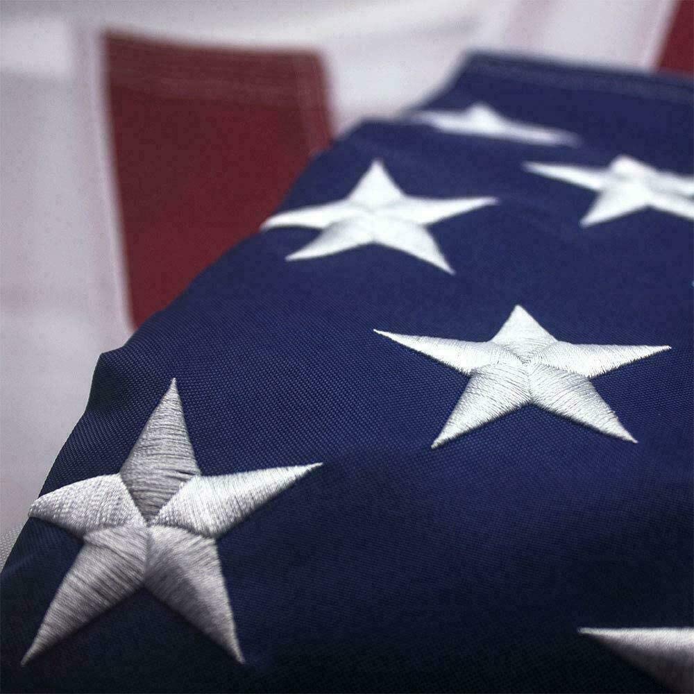 Close-up of an American flag with detailed stars and fabric texture.