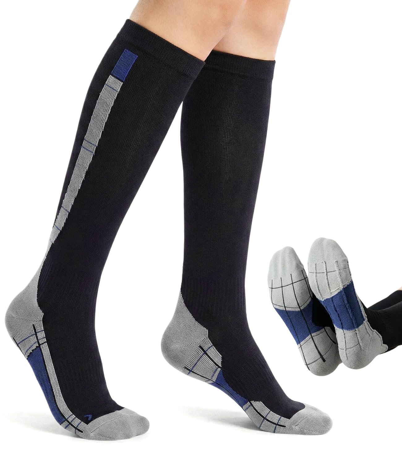 A pair of knee-high compression socks shown on a model's legs, with a small inset showing the socks folded. The socks are primarily black with gray and blue grid-patterned accents on the sides, heels, and toes.