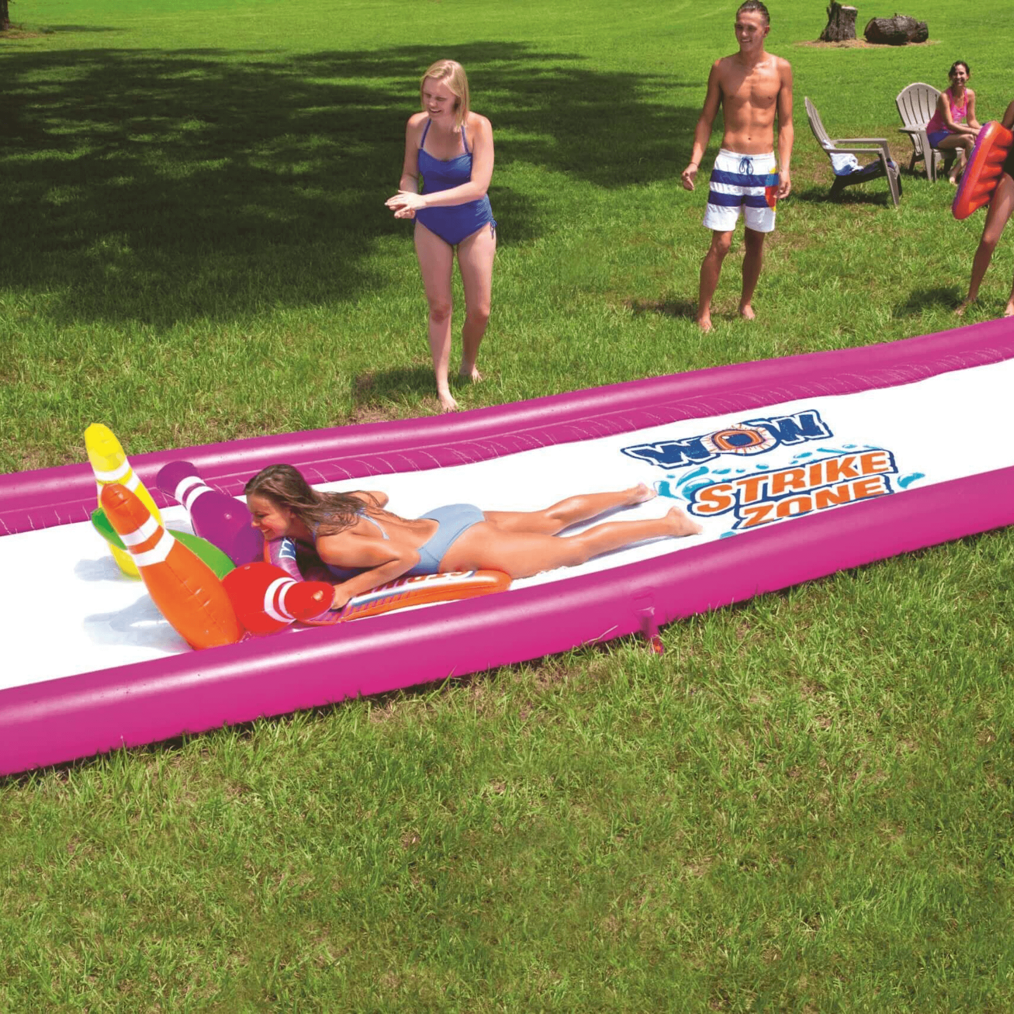 Inflatable slide with 'Show Strike Zone' branding on a grassy area with people around.