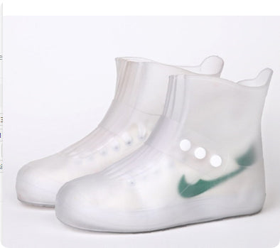 Clear rain boot covers with a green logo on a white background