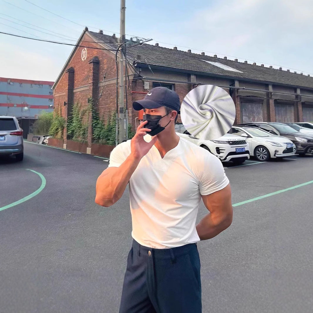 Man taking a selfie on a street with cars and buildings in the background