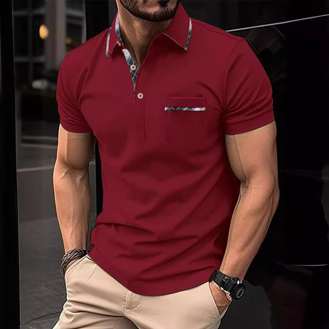 Man wearing a red polo shirt with a patterned collar and pocket, standing against a dark background.