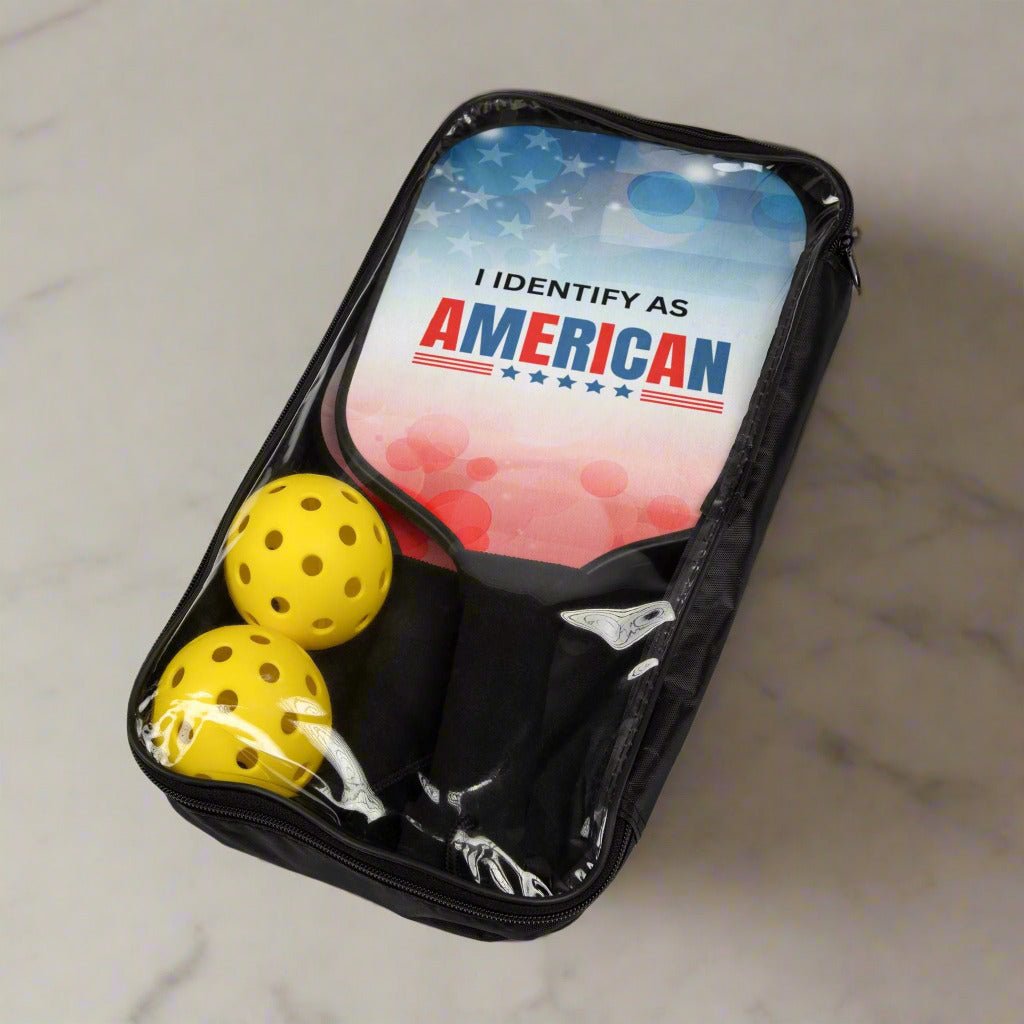 Black pouch with yellow balls and 'I IDENTIFY AS AMERICAN' text on a light gray background